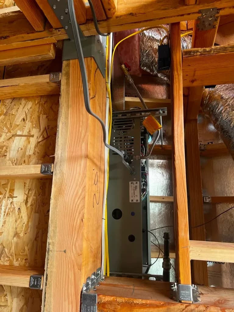 New HVAC air handler installed in wall framing with gas line connection