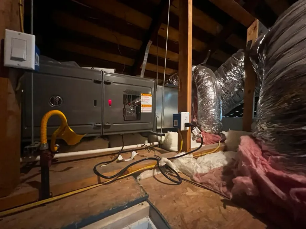 Attic-mounted HVAC unit with gas connection and ductwork