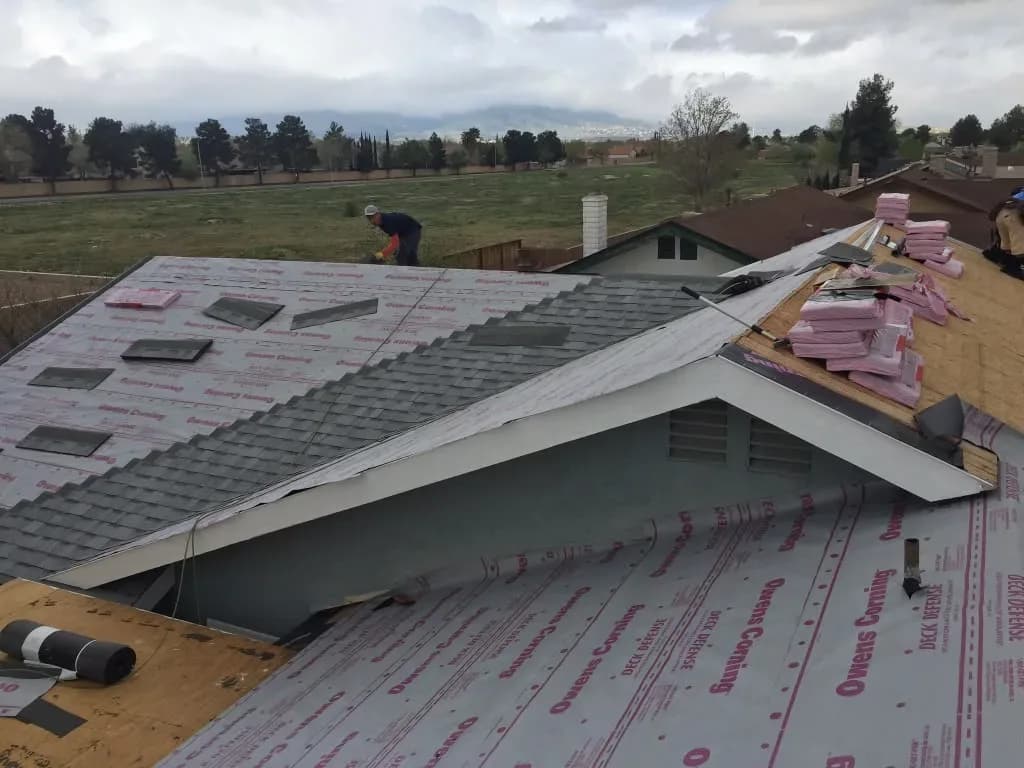 Wide view of a roof deck covered in underlayment with skylight cutouts marked