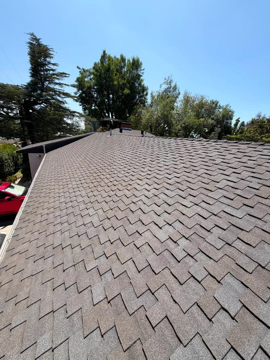 Completed asphalt shingle roof viewed down the ridge line