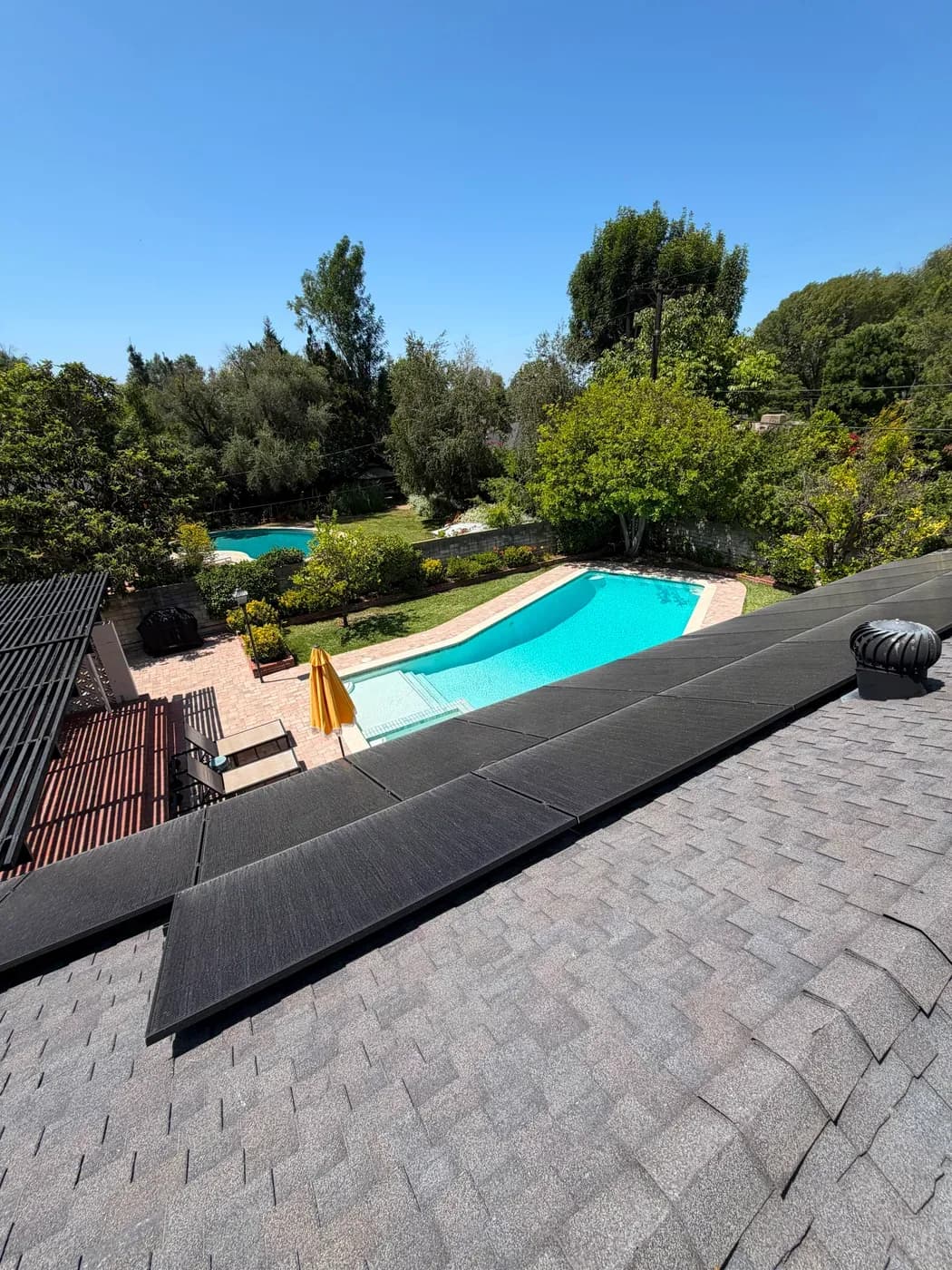 Newly shingled roof with solar panels and roof vents