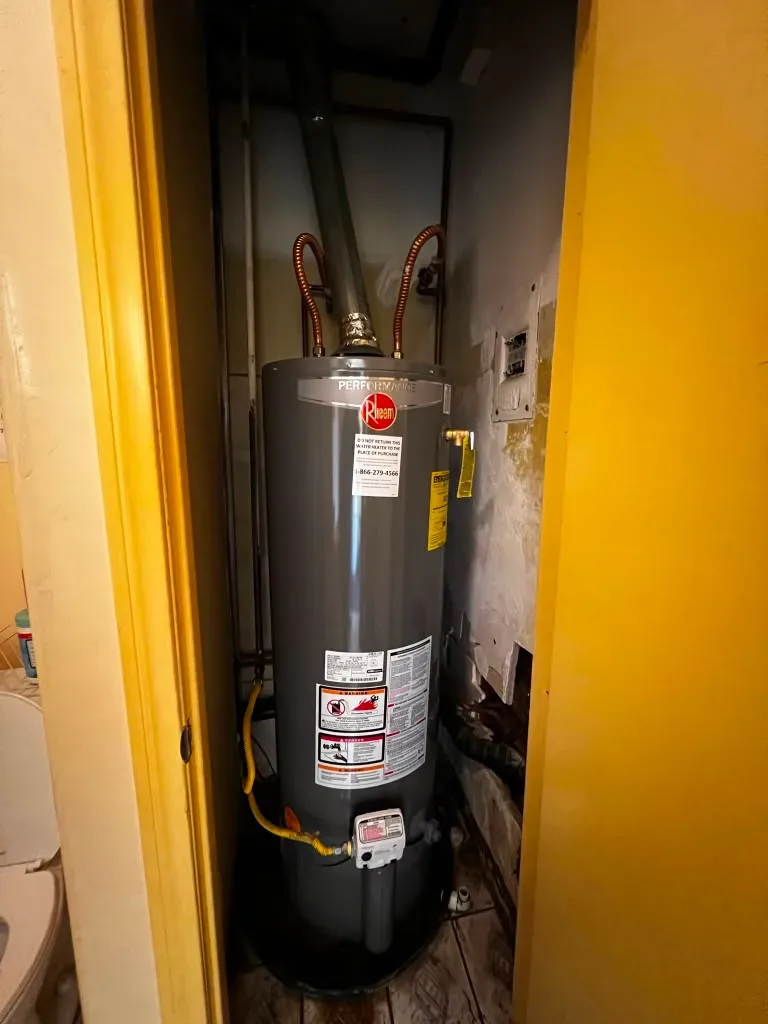 Water heater installed in bathroom closet during plumbing service
